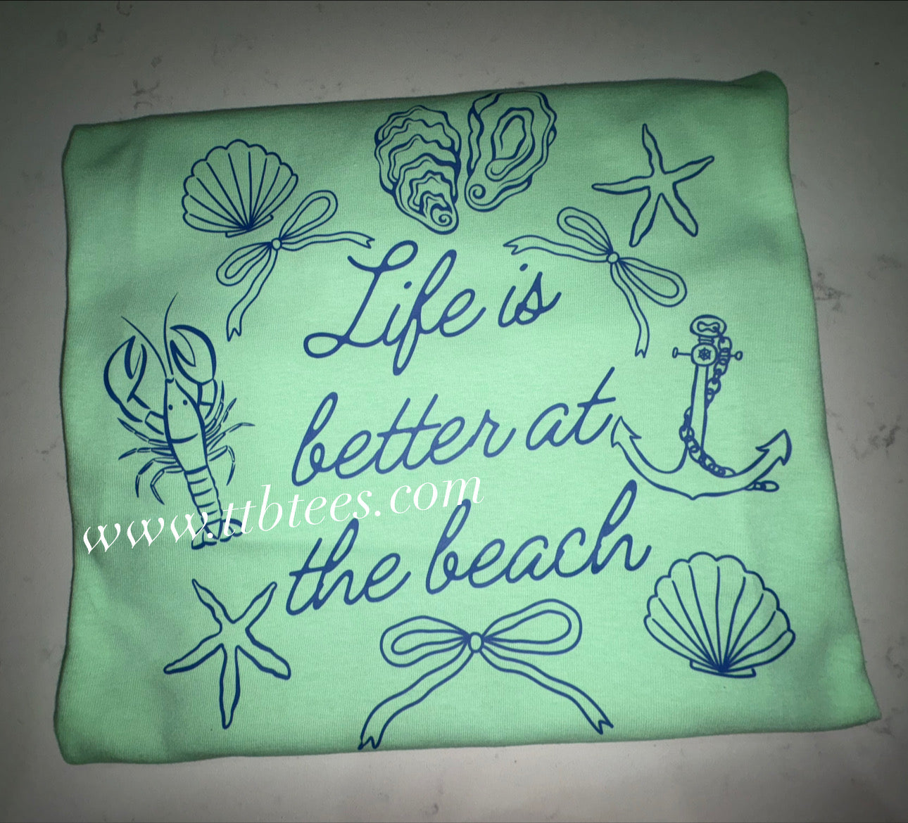 Life is better at the beach - blue writing